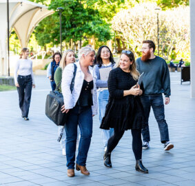 A group of students outside, walking towards ACAP Brisbane campus