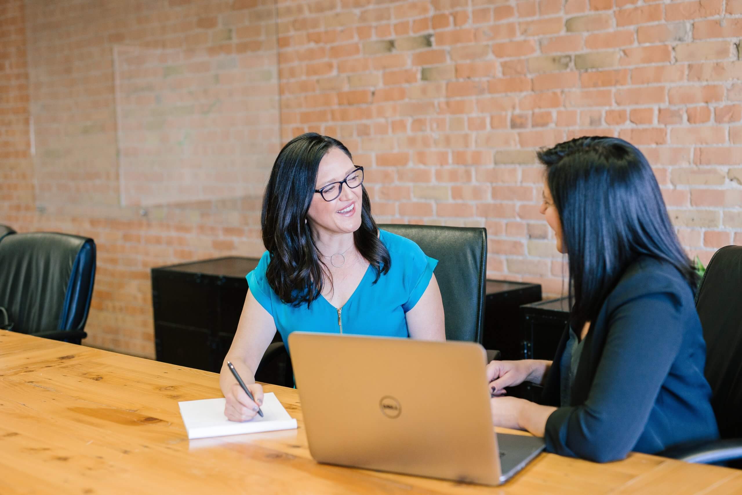 Two women at a desk.