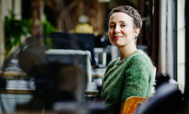 Image of a woman sitting at an empty office.
