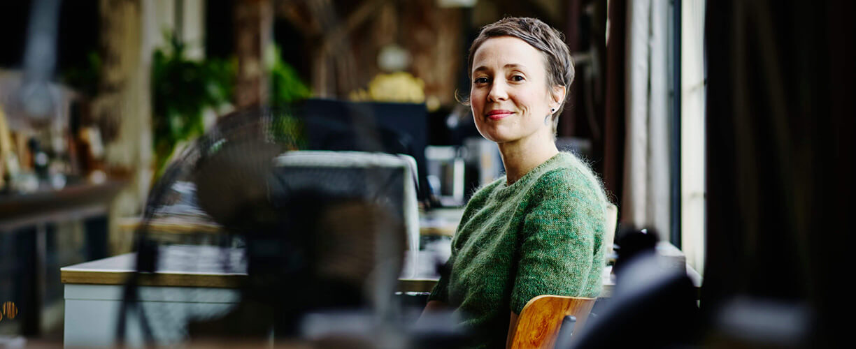 Image of a woman sitting at an empty office.