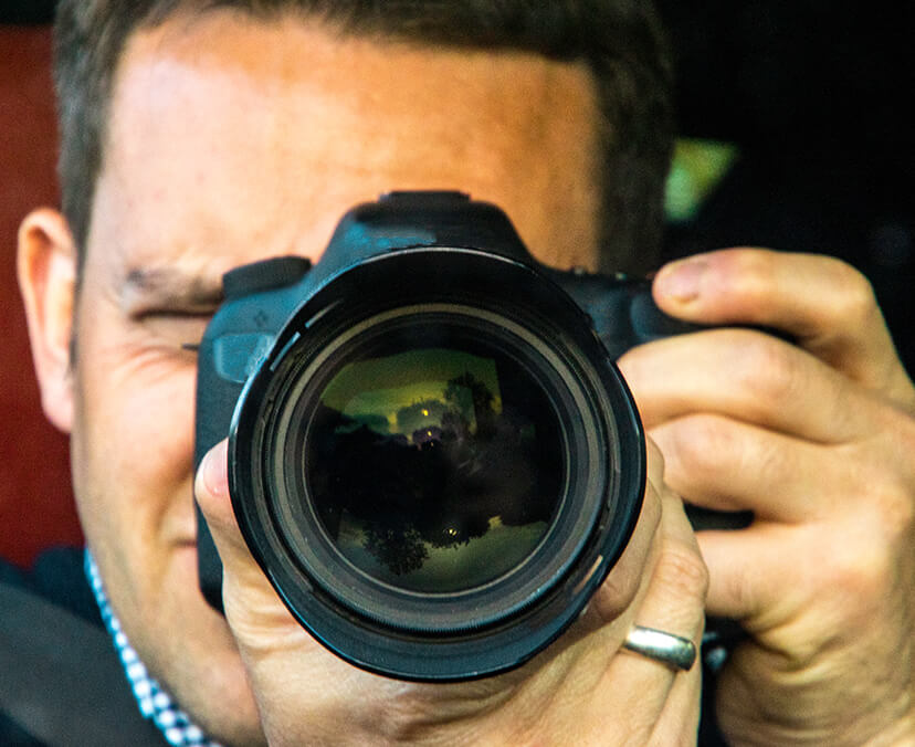 A man with a camera pointed forward.