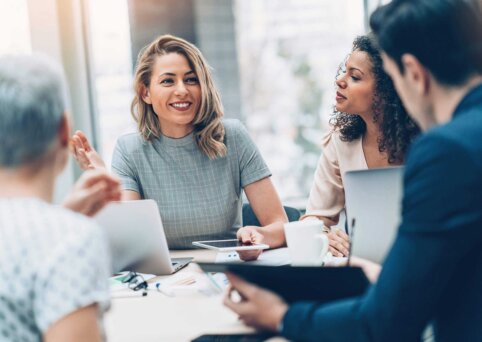 Group of business persons in discussion of legal practices.