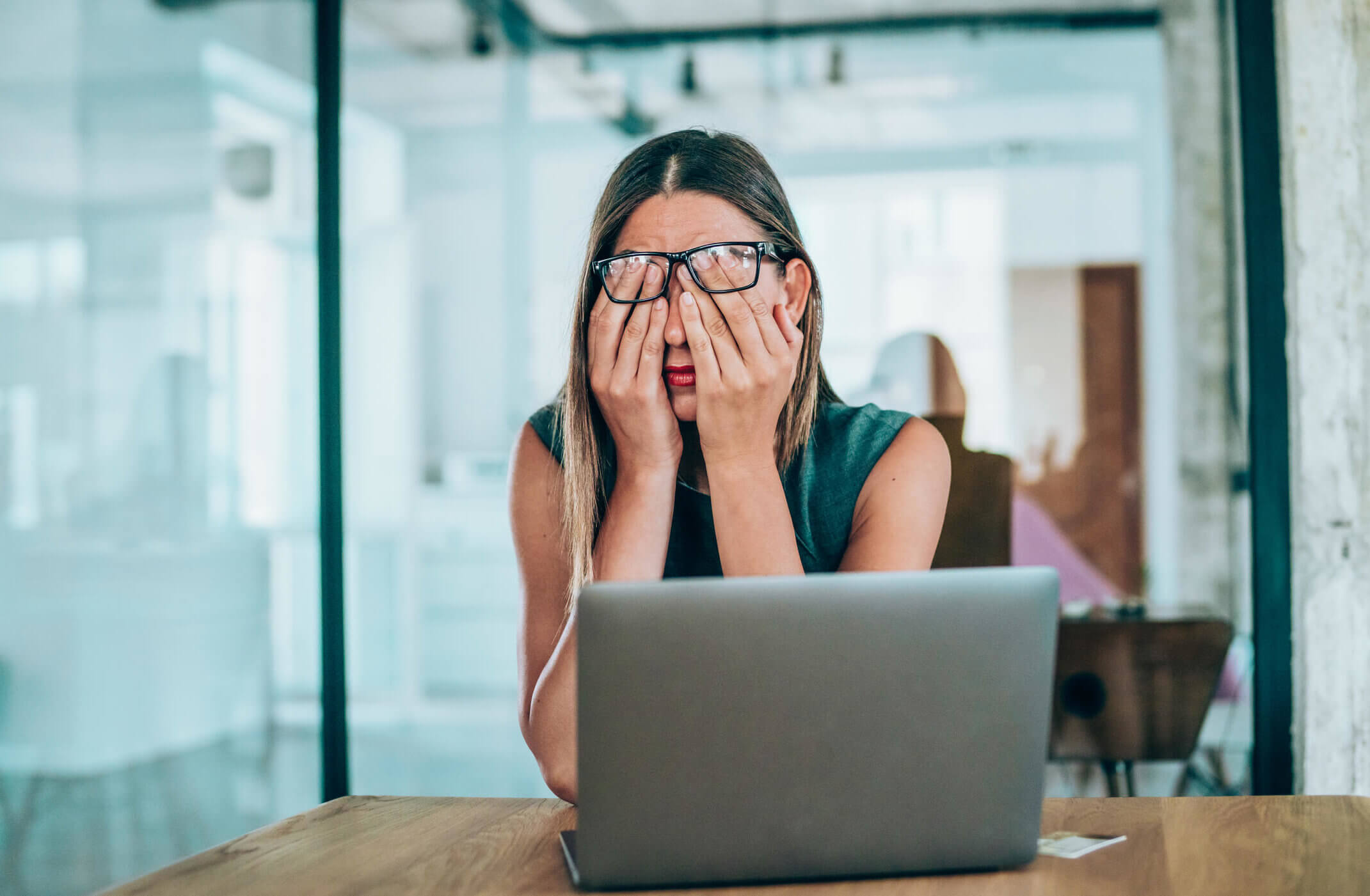 Female entrepreneur with headache sitting at desk