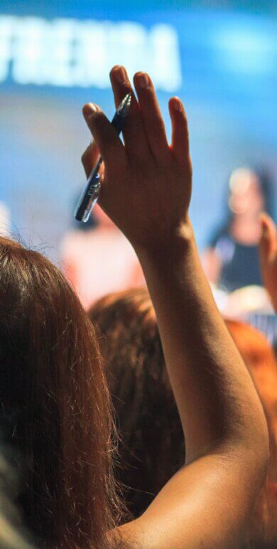 Hands raised in a lecture