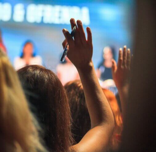 Hands raised in a lecture