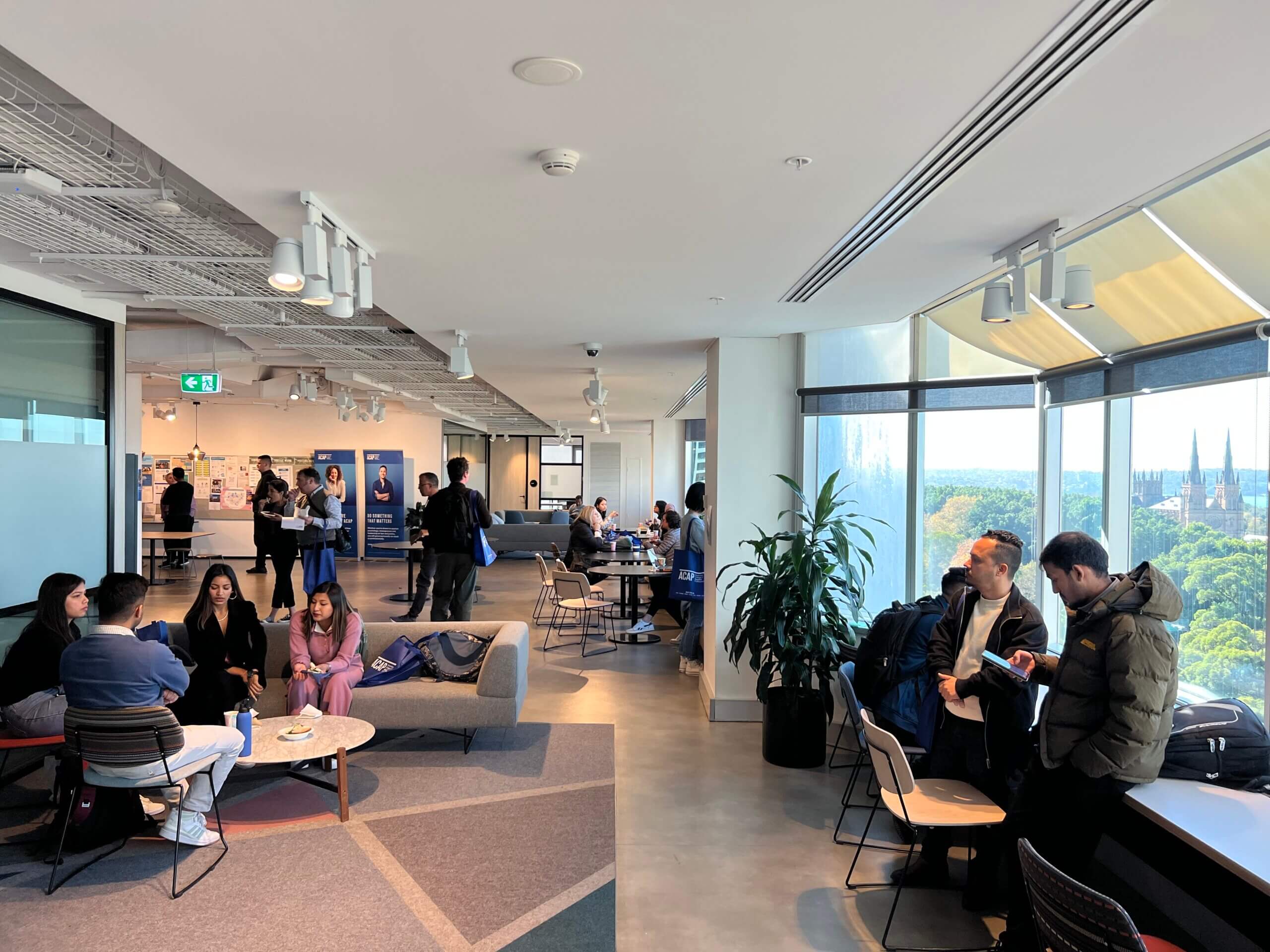 Wide shot of prospective students attending an event on level 12 of the ACAP Sydney campus building