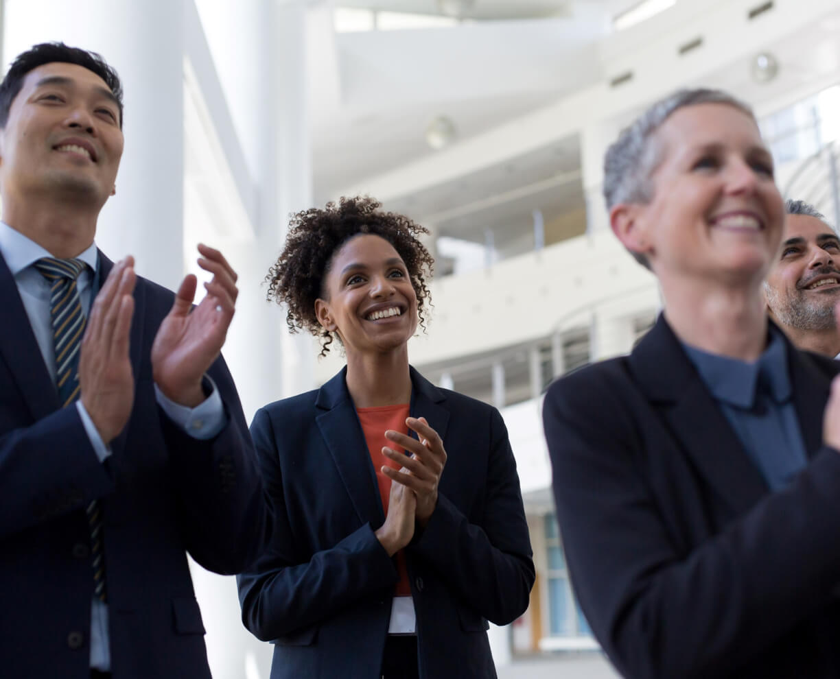 Four colleagues clapping at a business event ACAP Careers Culture