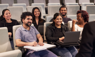 group of students in lecture theatre smiling
