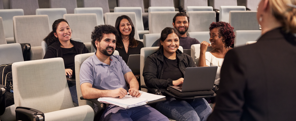 group of students in lecture theatre smiling