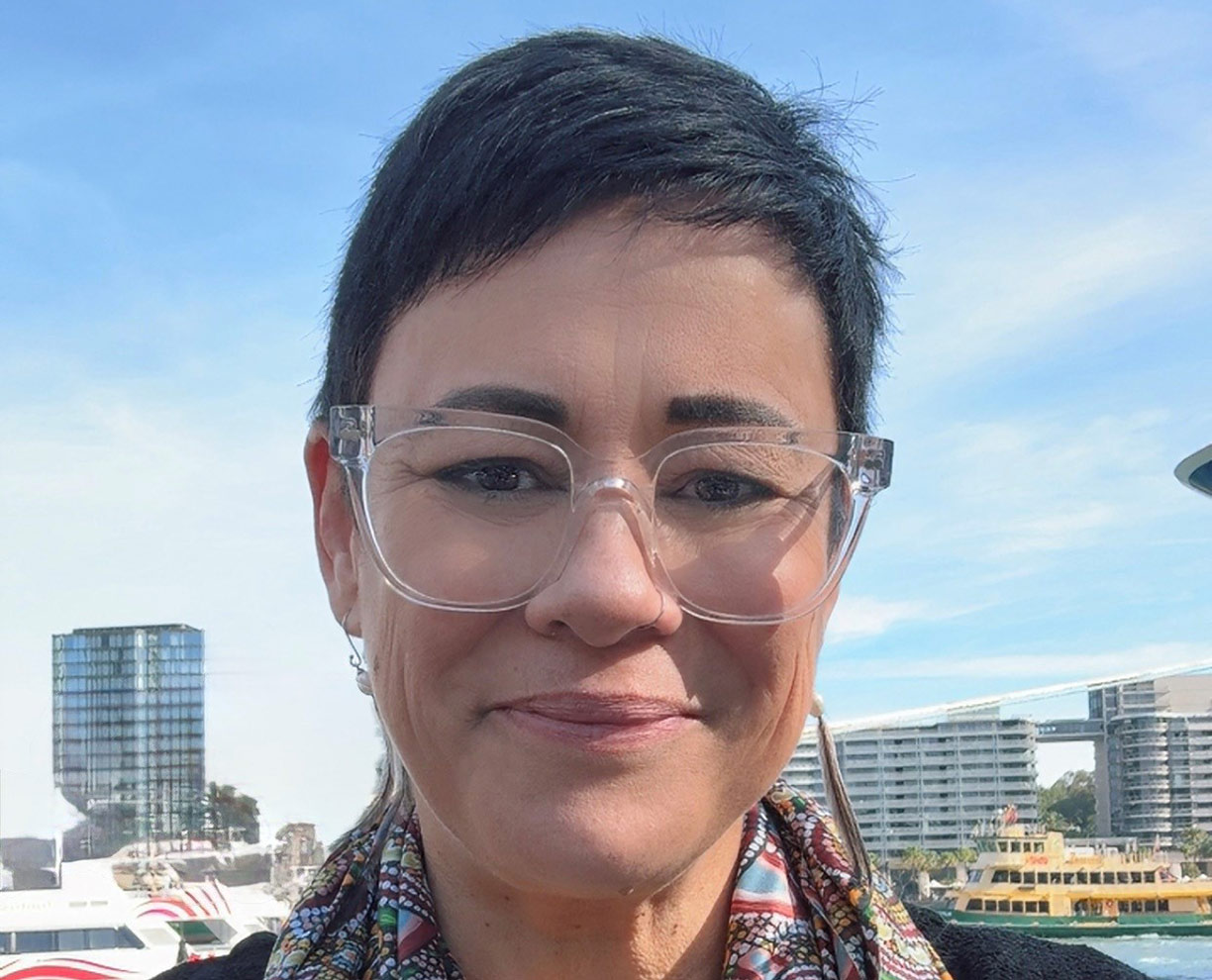 Profile photo of Mellissa Johnson, Bachelor of Social Work alumni standing in front of Sydney Harbour - Student and Alumni Success stories