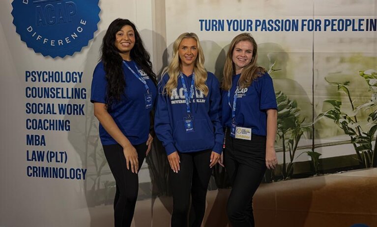 Three course advisors standing at the ACAP University College booth of the Sydney HSC & Careers Expo (828x676)